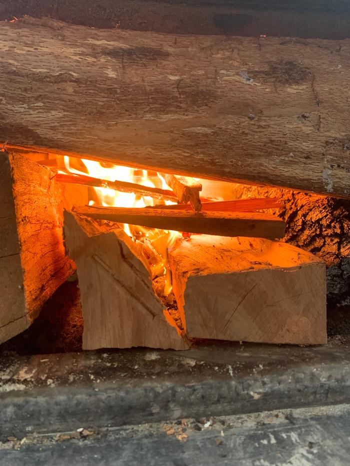 Th bottom middle medium sized pieces have a roughly canoe shaped cavity for catching coals and siphoning O2 rich intake air through channel below parallel bottom logs