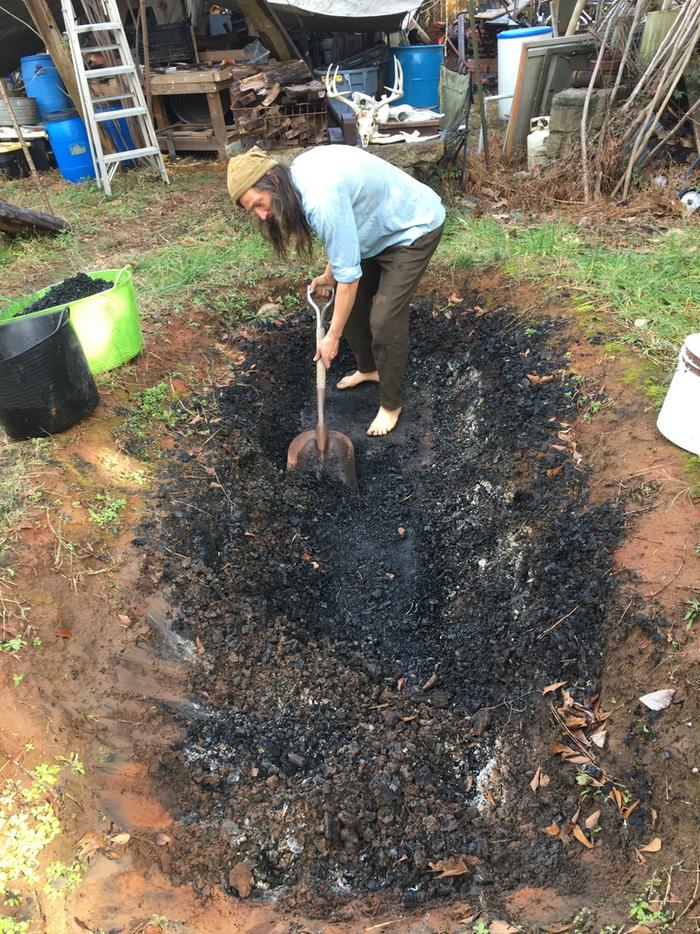 emptying the rest of the char from the pit, transferring to the totes