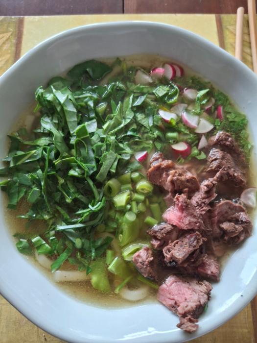homemade broth with noodles, kale, radish and some peas and garlic scapes from the larger garden