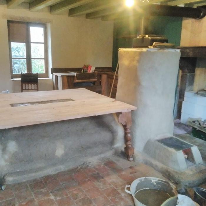 rocket masonry heater with a mass underneath a kitchen table