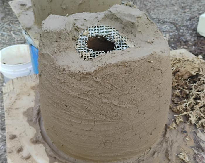 The embedded stainless mesh will hold a coffee cup ...and also I'm hoping it will be an ignition source for any excess fuel 