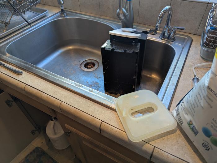 instant hot water heater disassembled in a sink