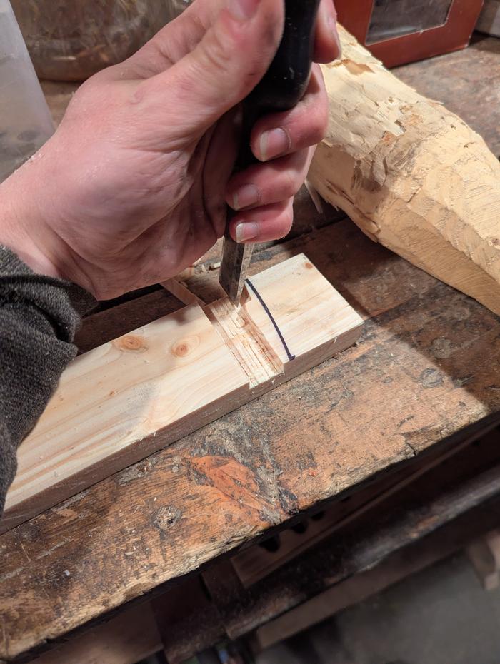Carving a slot in wood with a chisel