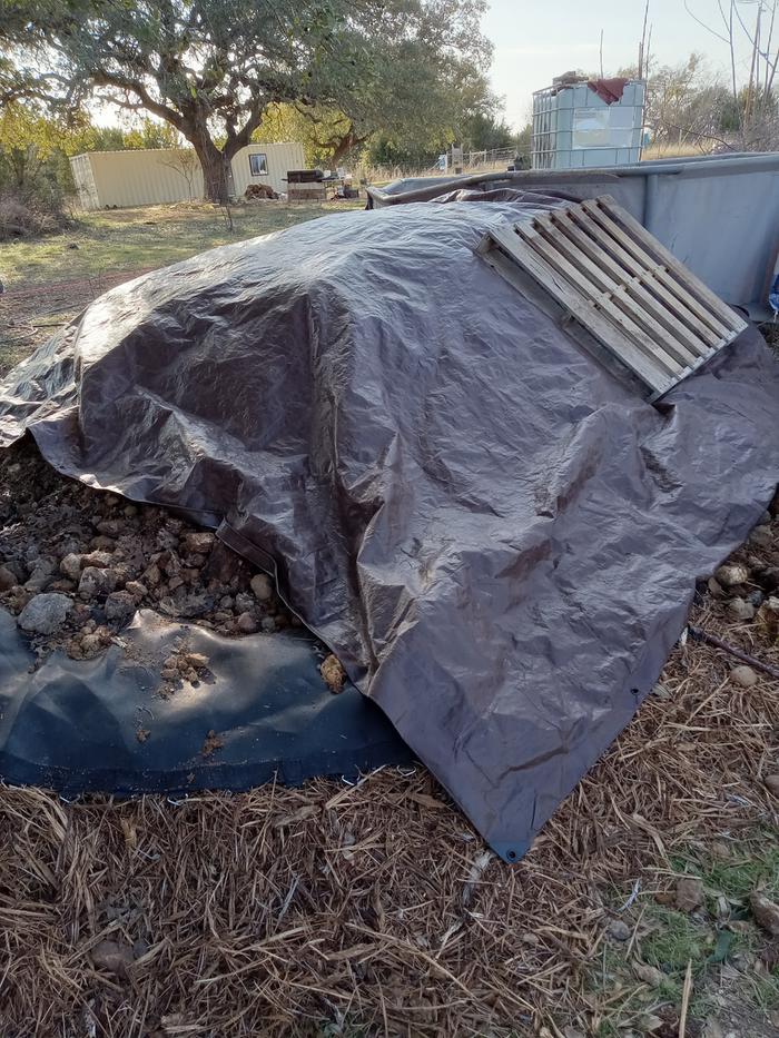 The tarp keeps moister in and helps outer part of material decompose
