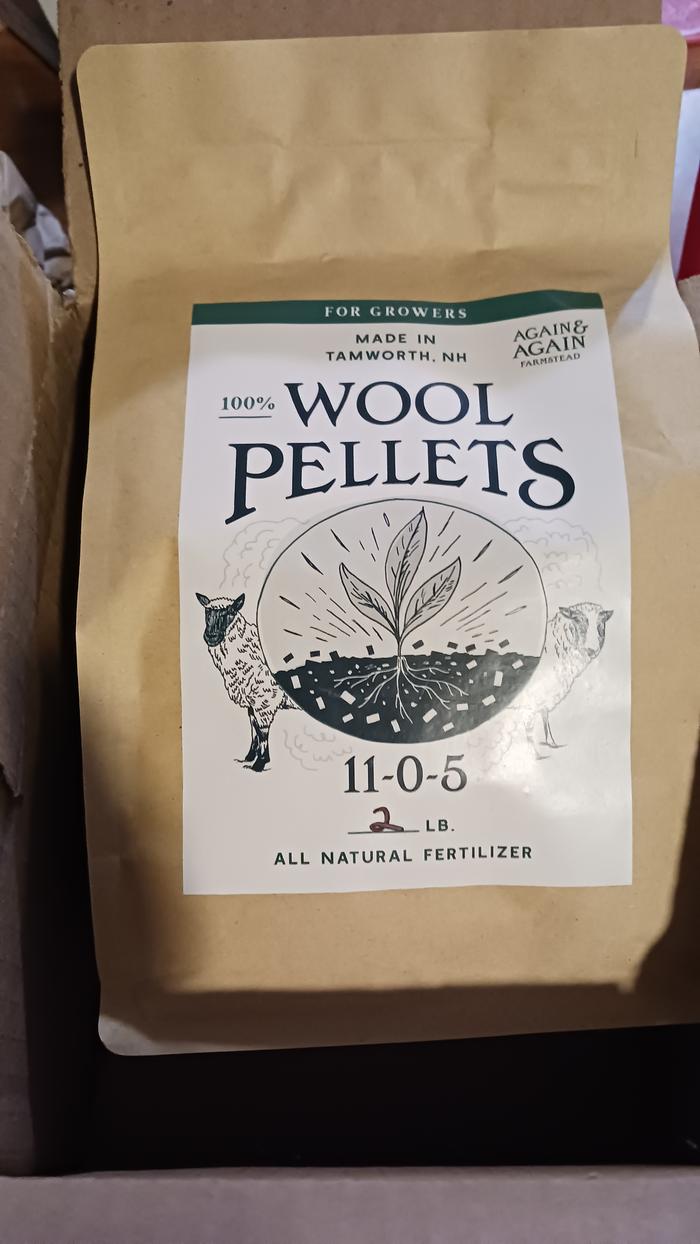 the front of a two pound bag of wool pellets. NPK ratio of 11-0-5
