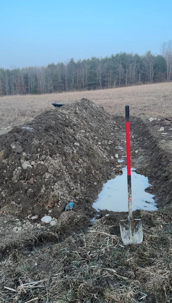 Third layer of logs covered with dirt 