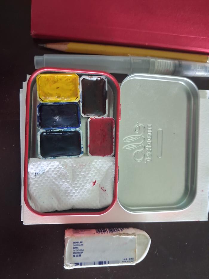 Pretty watercolours with paper towel to wipe my brush in a little tin