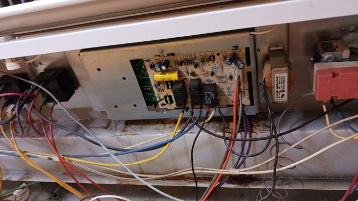 Control assembly held in place by the rotary switches on both sides of it