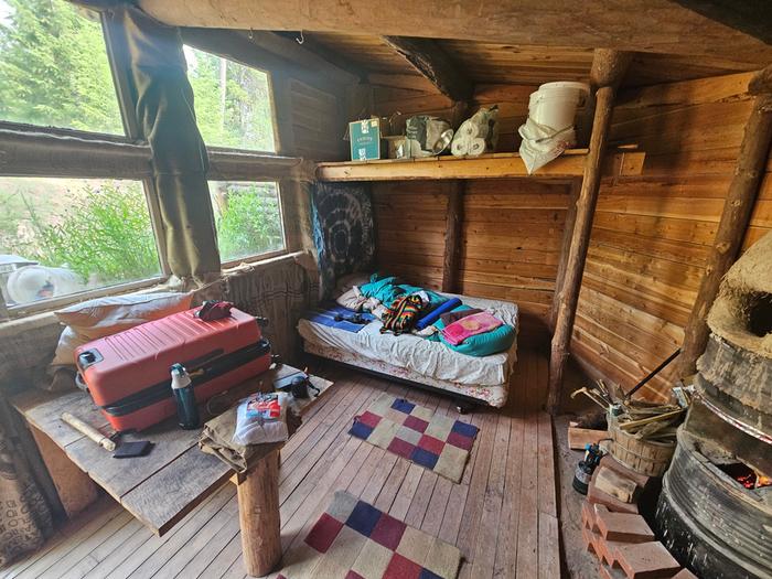 the bed and some rugs in the dogstar underground house