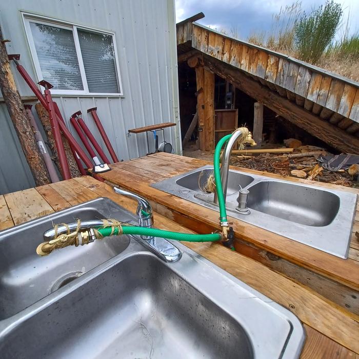dishwashing station sinks with hoses attached to the faucets so that they can be foot pumped or pressurized