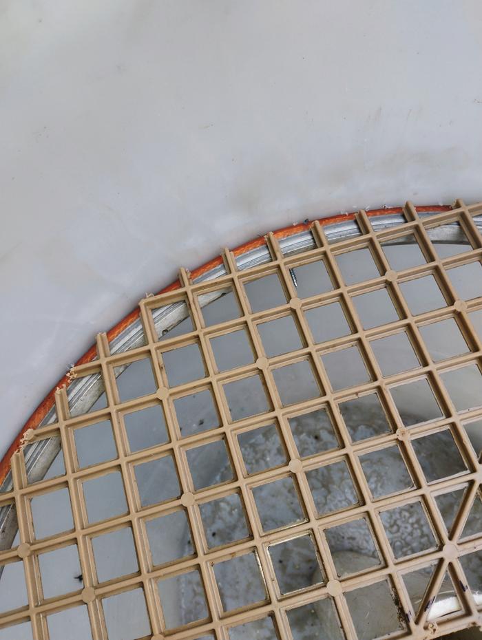 Bicycle rim, bread tray mesh, sections of garden hose as spacers, secured with pole barn screws