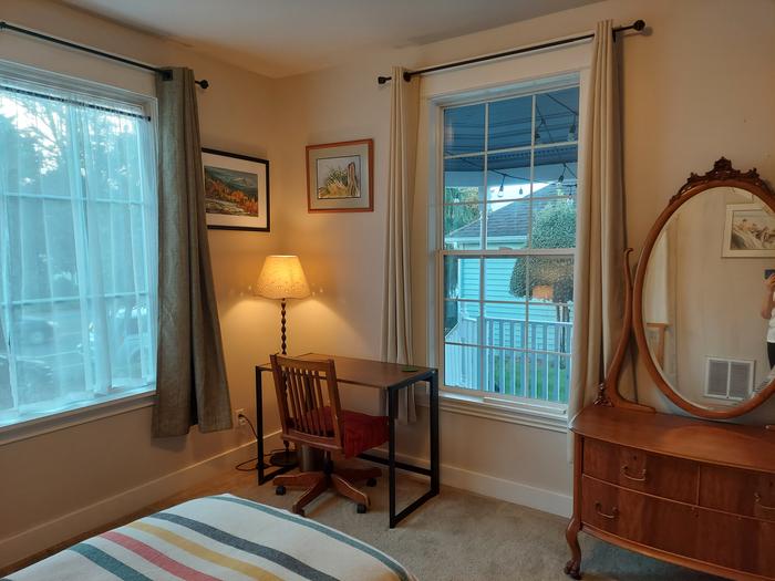 den desk in between East and South facing windows