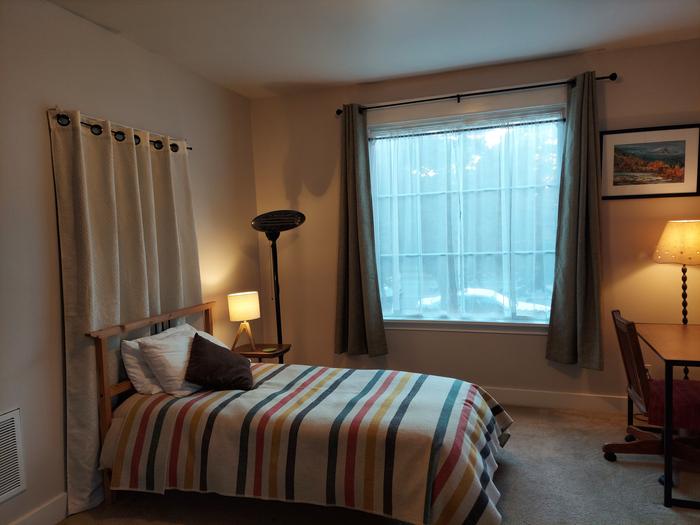 den with twin bed and East facing window (curtain hides an unused door to upstairs unit we do not access)