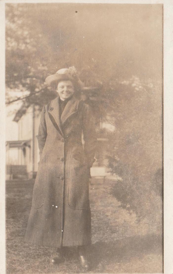 old family photo of woman in long coat