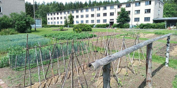 a garden in front of an old german barracks building