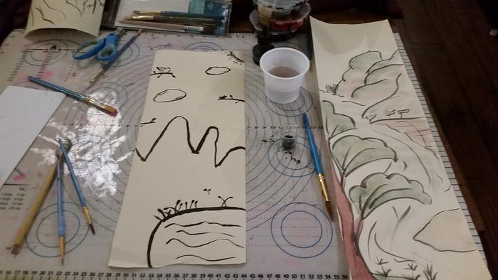 The finished paintings. My son thought my daughter's was much better than mine. Mine sure could have been better! Adding color helped, though.