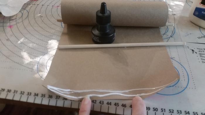 Applying glue tot he already curled paper. I really should have ironed it--I ironed my daughter's. But, I wanted to test on mine to see if it was necessary.