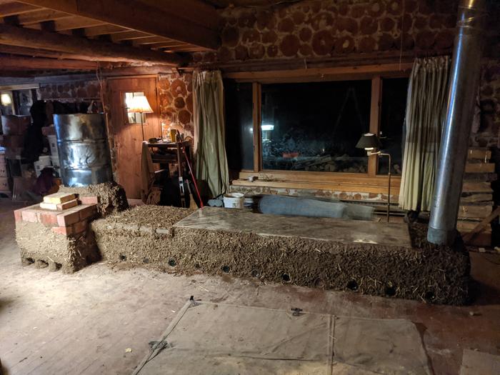 a rocket masonry heater in a cordwood cabin