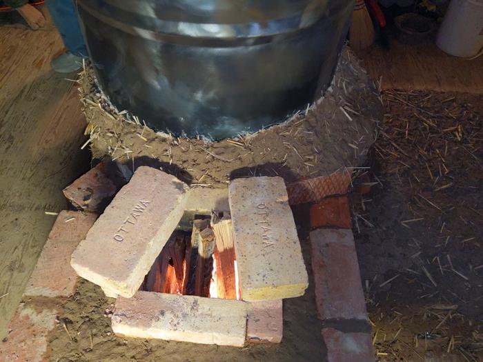 The first fire in the new rocket masonry heater. Firebricks stamped 