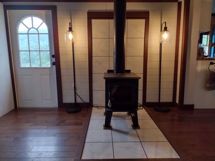 Duolit Spark II glass-front wood stove with double/triple wall piping & marble tile hearth
