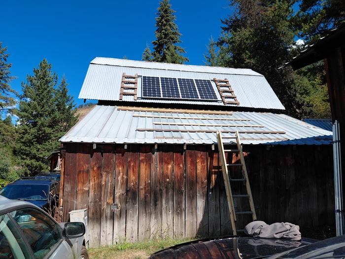 solar panels set up on barn roof to run freezer