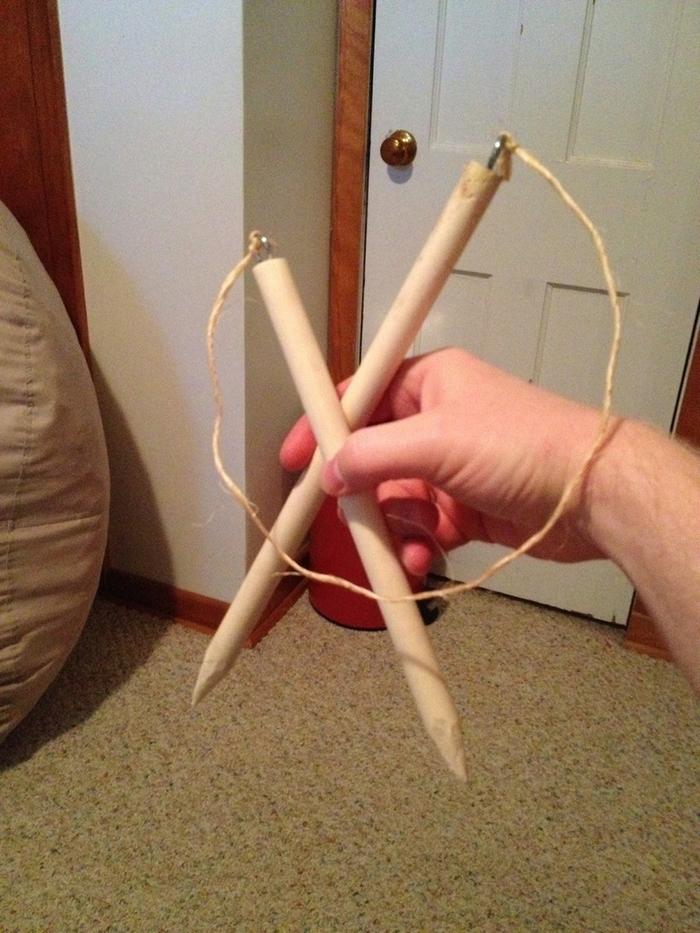 whittled dowels, eyelets, and rough twine