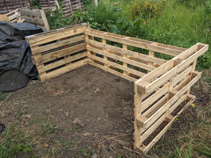 Double-width pallet composting bay, held together by corner brackets & screws.