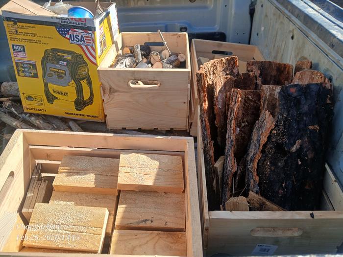 woody bits and bark in crates in the back of a truck