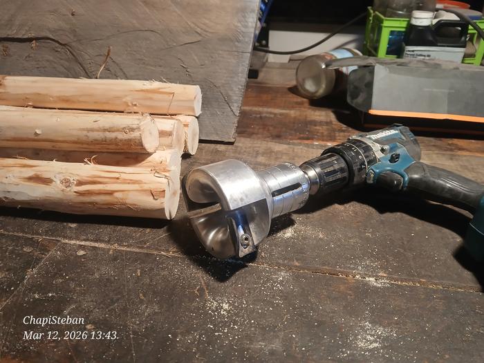 a tenon cutter in a drill next to sticks that will be shaped