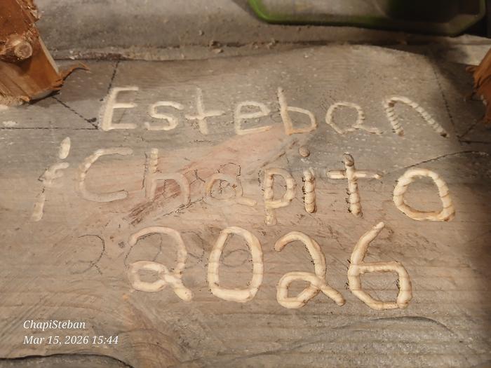 Esteban carved his name into the bottom of the end table that he built