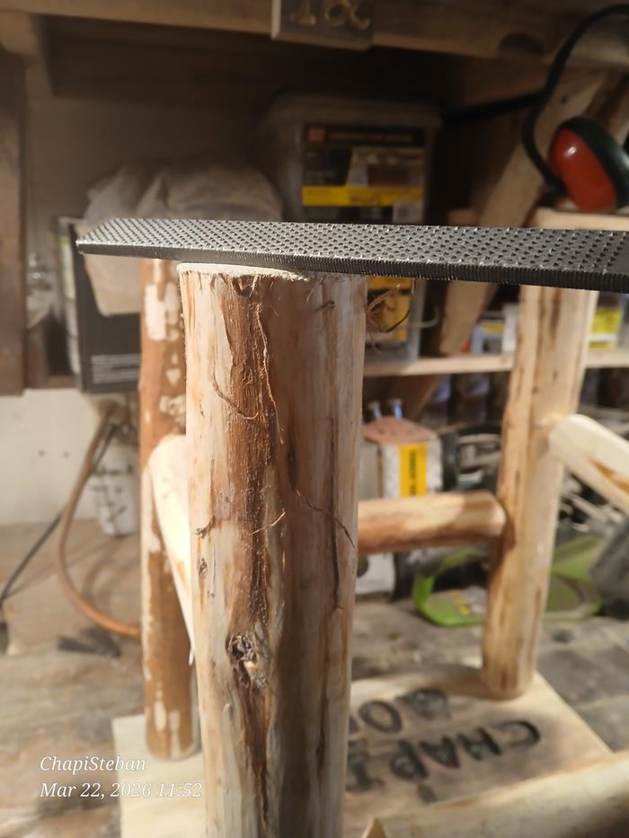 A rasp on the leg of a stool