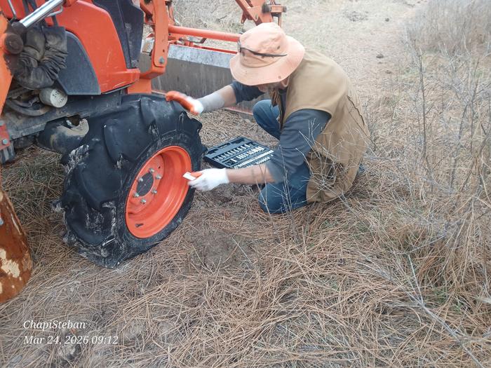 Stephen working on dismounting tractor tire 