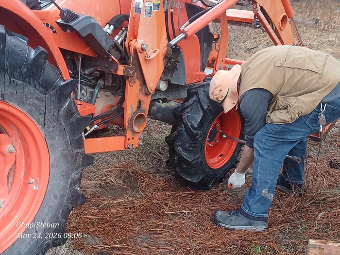 Stephen works on the tractor wheel