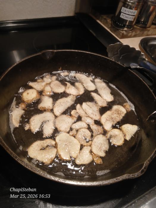 sunchoke slices frying in a cast iron skillet
