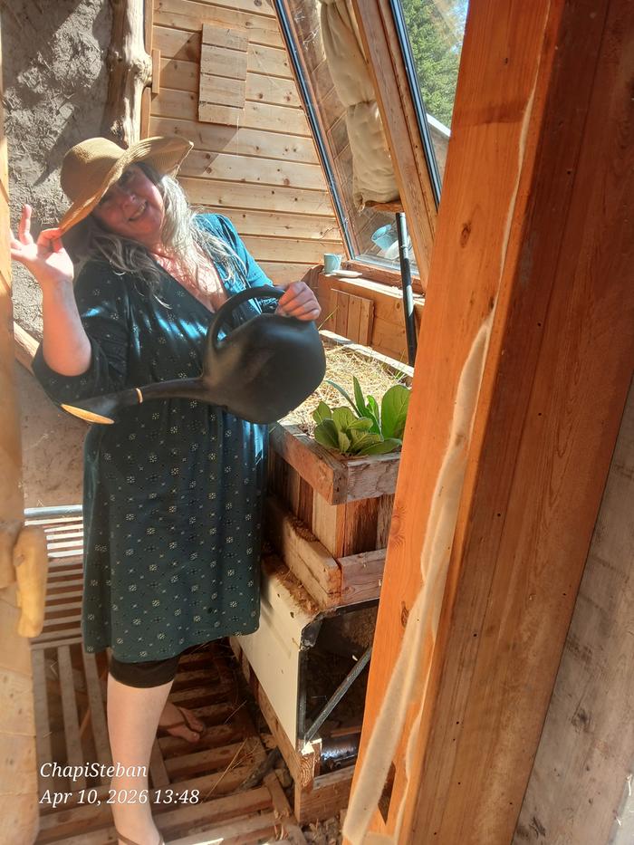 Melissa watering in the greenhouse 