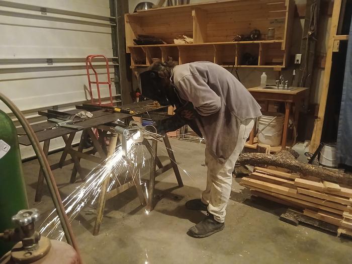Seth working on the greenhouse hinge 