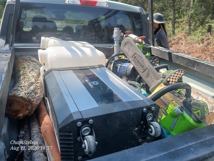 a bunch of electric equipment for irrigation and cutting trees in the back of a Ford Maverick