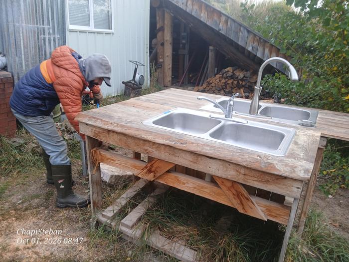 Bringing outdoor sinks inside the classroom, so Stephen can dump a load of mulch for the top of bermshed 