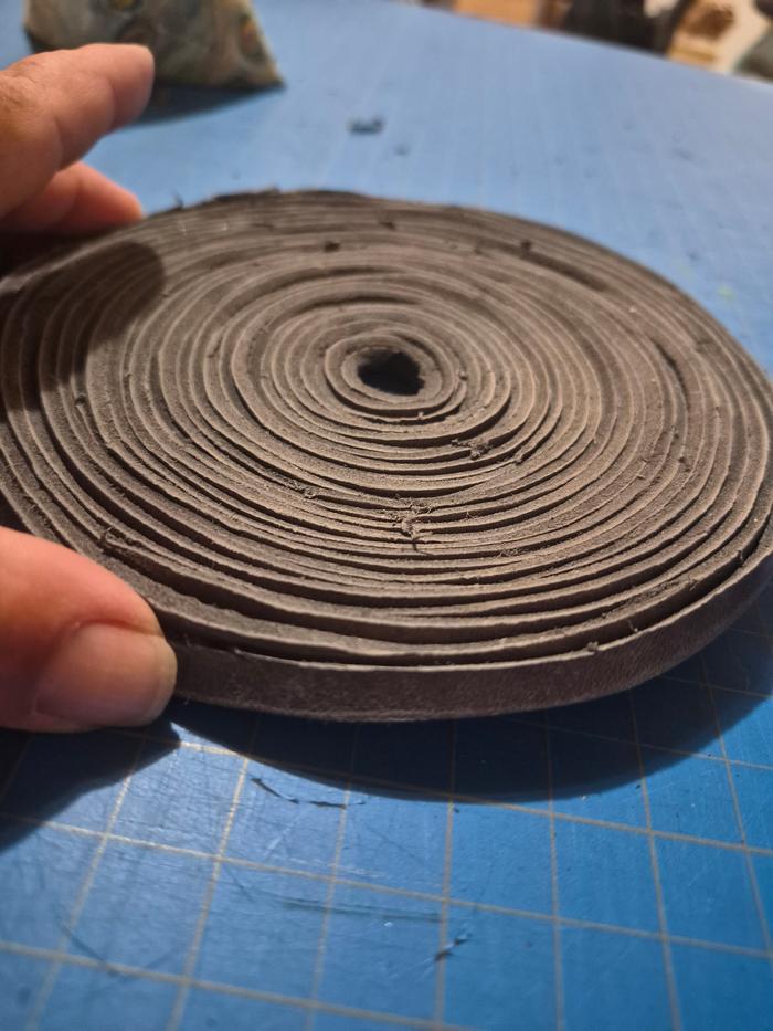 Coiled leather cordage showing consistent thickness throughout 