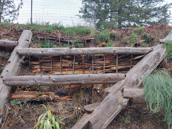 Sticks and scrap wood help keep soil up high on the hugel. 