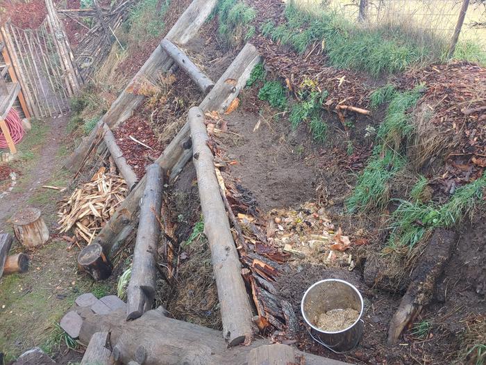 Filled in the "trough" with wood, dead plants, pine mulch, sand, and soil. 