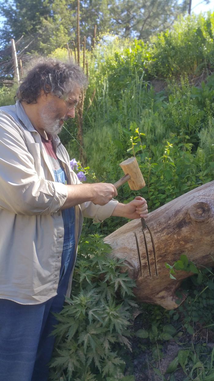 paul chiseling the log on the left / north