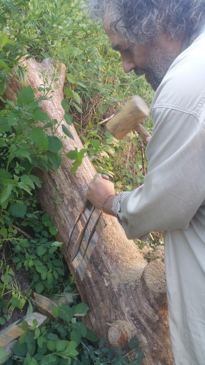 paul chiseling the log on the right / south end