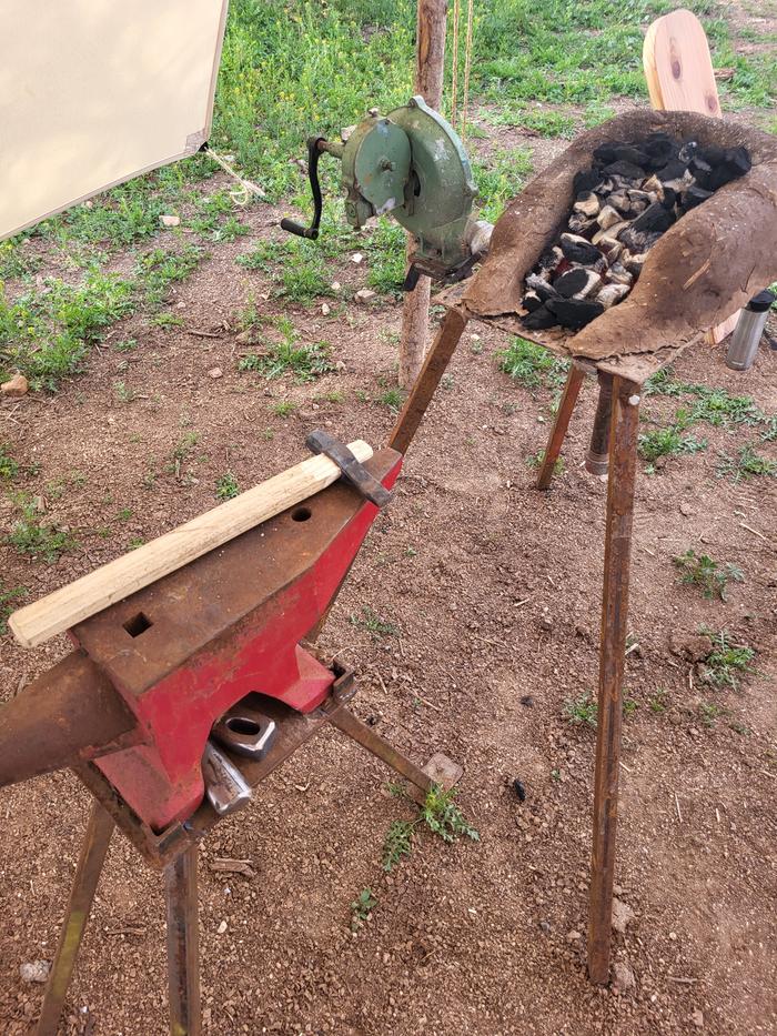 Hand cranked blower with cobbed walled forge.