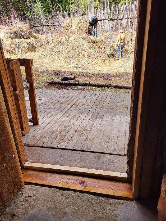 Finished Abbey front door threshold fix looking out at Esteban and Stephen working the Hugels