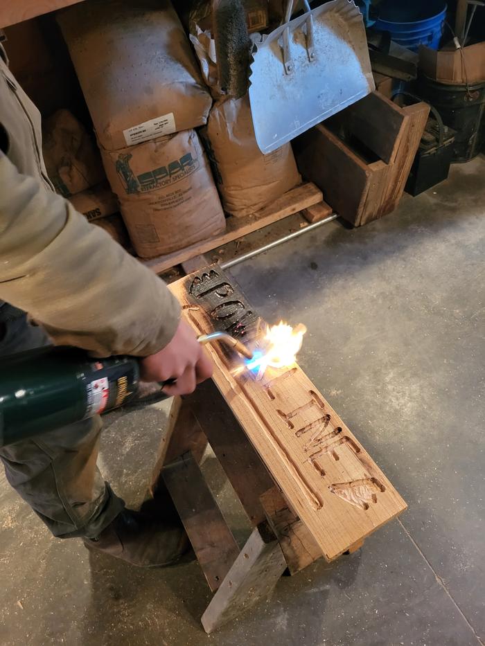 Fire! Burning the sign to have our letters "pop"