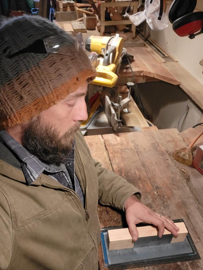 then very fine grit sandpaper applied to a glass surface was used to further polish the filed surface...