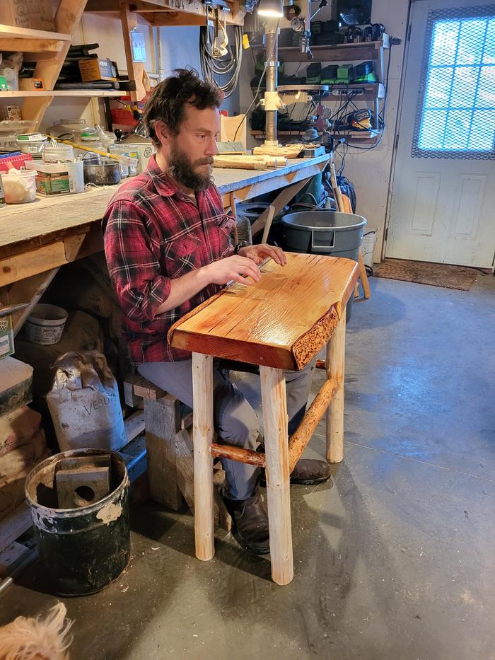 Demonstrating how the end table coul be used as a desk...