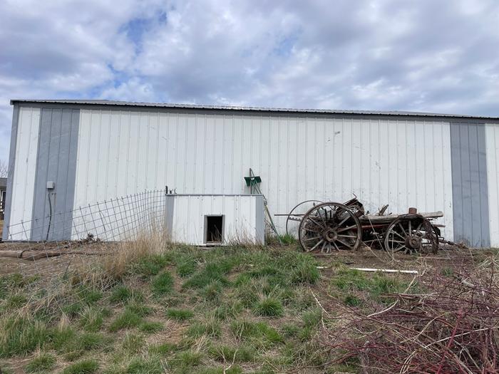 South side of white shop. Wagon and dog house can be removed