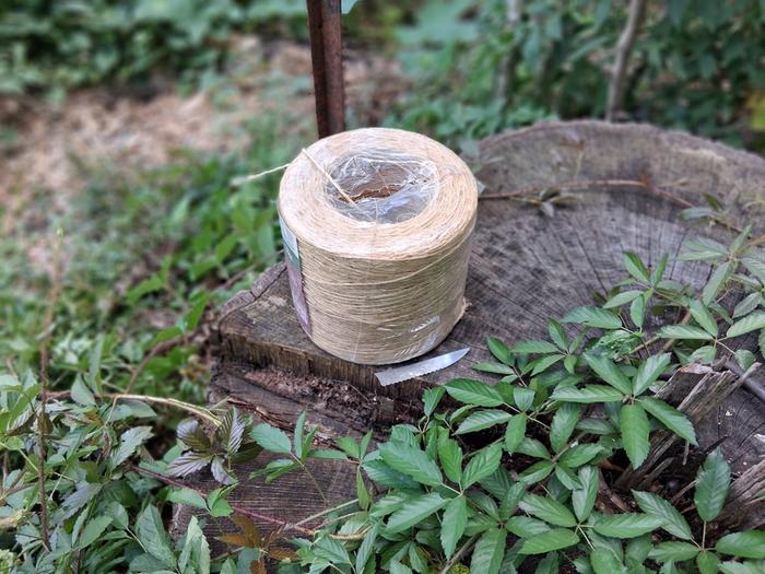 knife blade next to roll of string